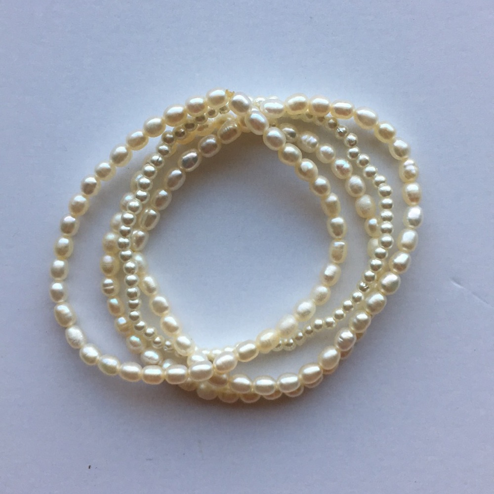 Thin pearl bracelets.